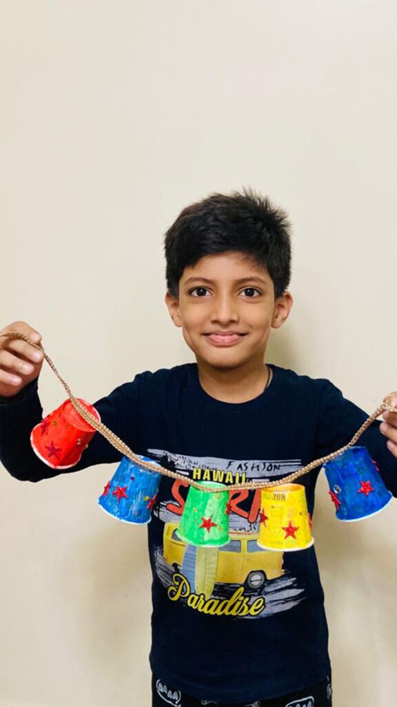 He is making a wall hanging with glasses for Cyboard School activity