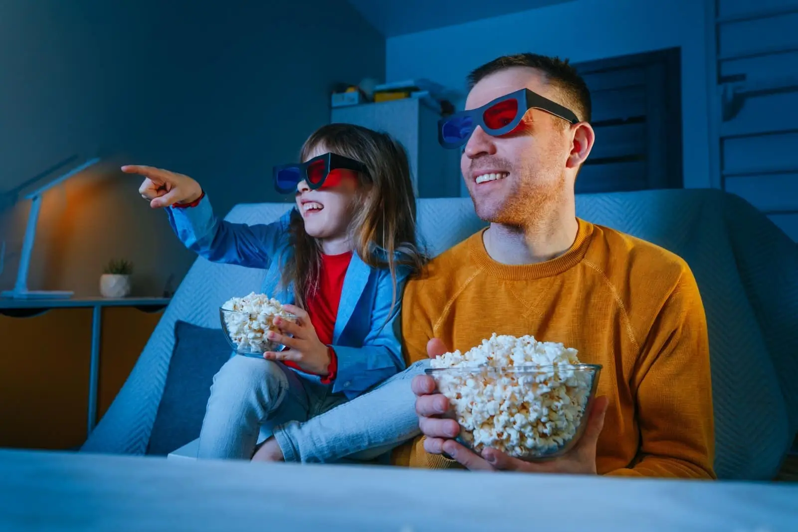 Father and kid with popcorn in hands