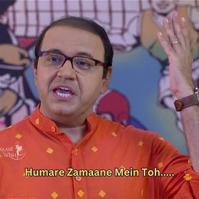 A man in orange shirt with hand raised